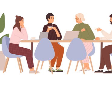 Groep van mensen die overleggen aan een tafel